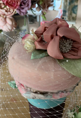 Powder pink Coquette pillbox hat with birdcage veil in the making